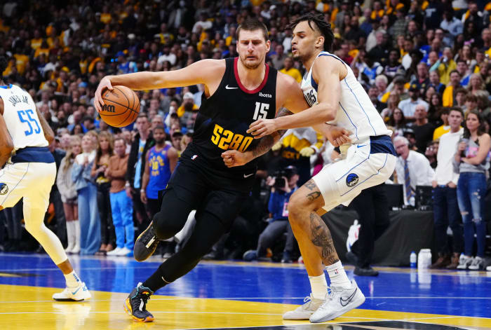 Dallas Mavericks rookie Dereck Lively II defends Denver Nuggets' Nikola Jokic.